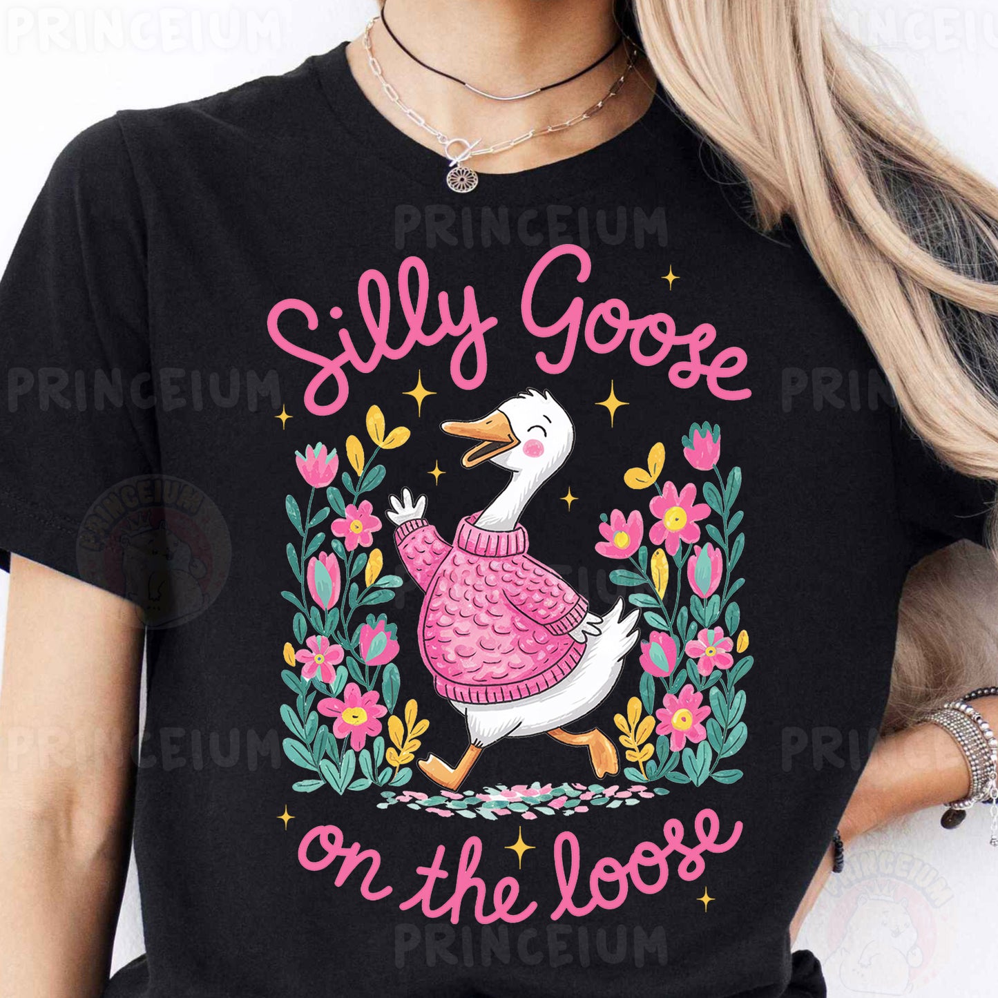 a woman wearing a black t - shirt with a duck wearing a pink sweater