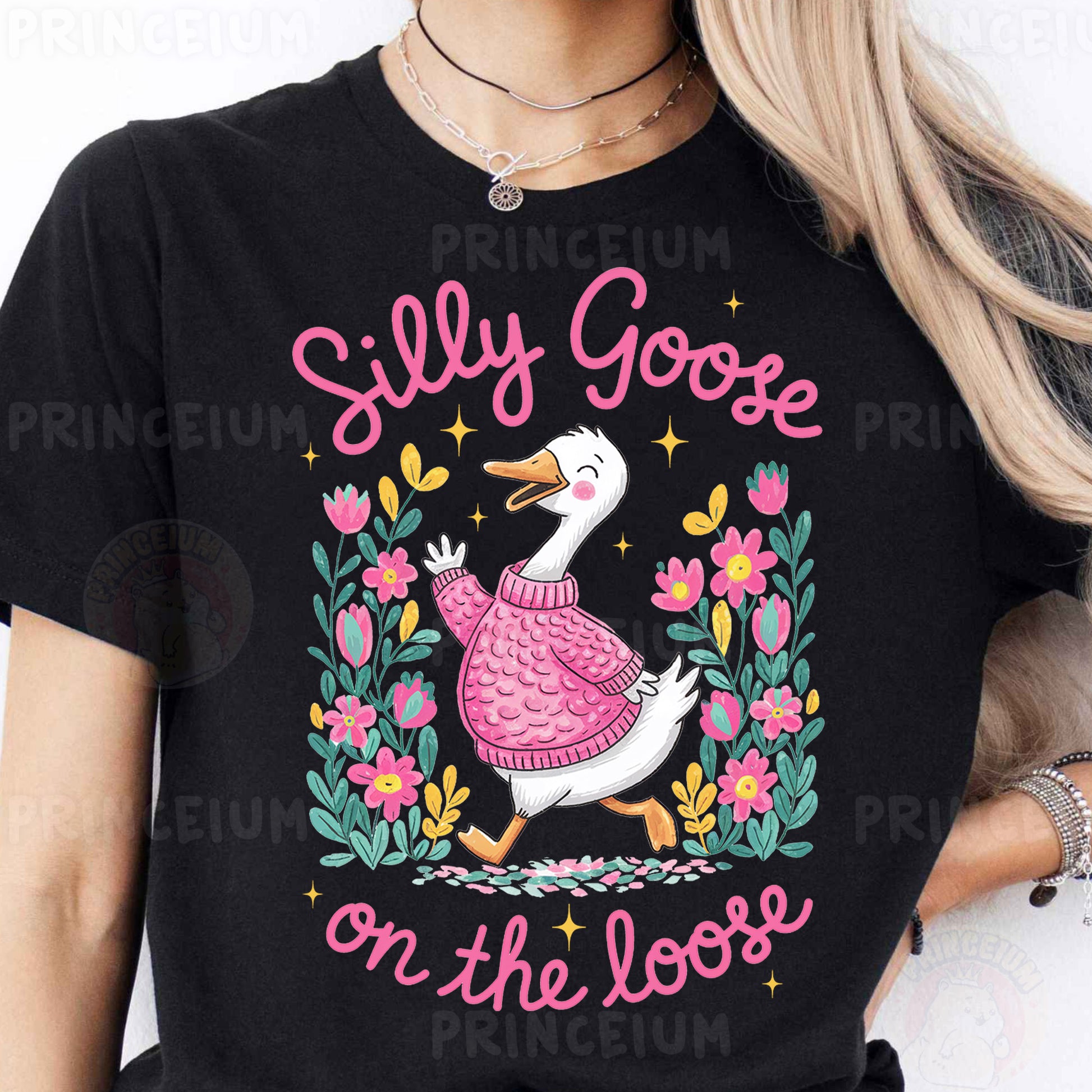 a woman wearing a black t - shirt with a duck wearing a pink sweater