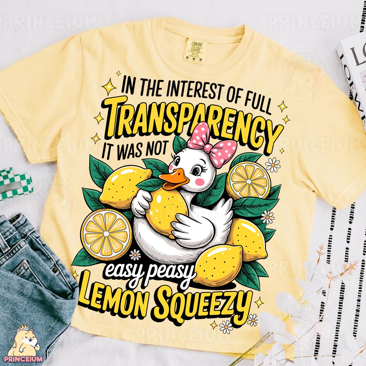 a yellow t - shirt with a picture of a duck holding a lemon