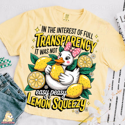 a yellow t - shirt with a picture of a duck holding a lemon
