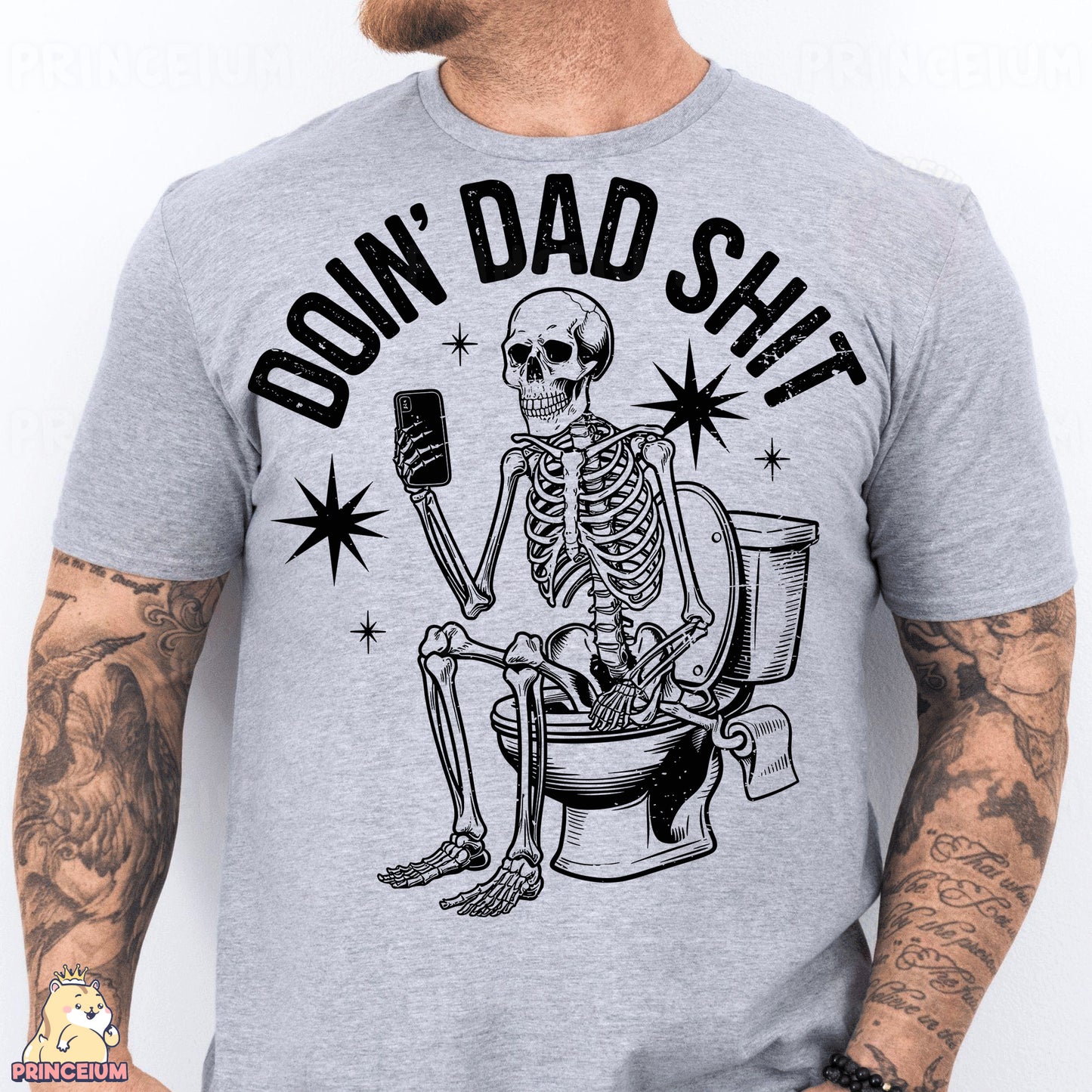 a man wearing a gray shirt with a skeleton sitting on a toilet