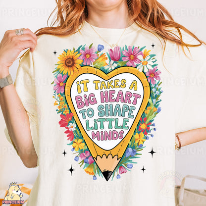 a woman wearing a t - shirt that says it takes a big heart to shape