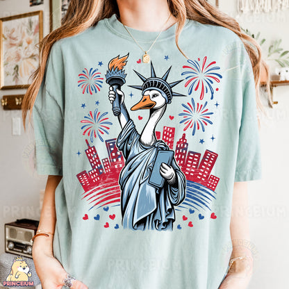 a woman wearing a t - shirt with a picture of the statue of liberty