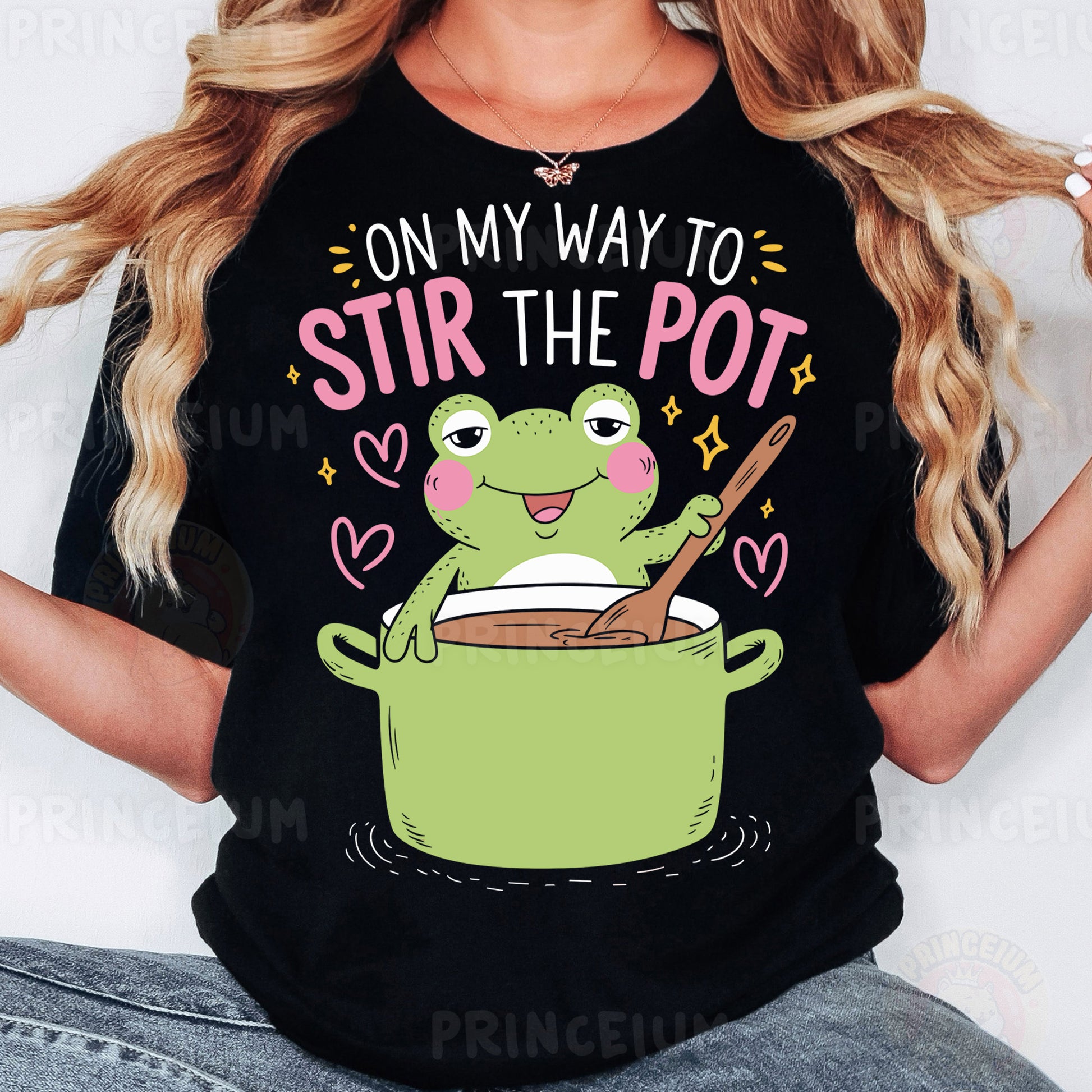 a woman wearing a black t - shirt with a frog in a pot on her