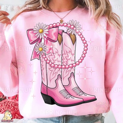 a woman wearing pink cowboy boots and a pink sweater