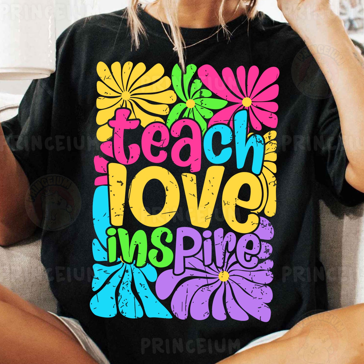 a woman sitting on a couch wearing a t - shirt that says teach love inspire