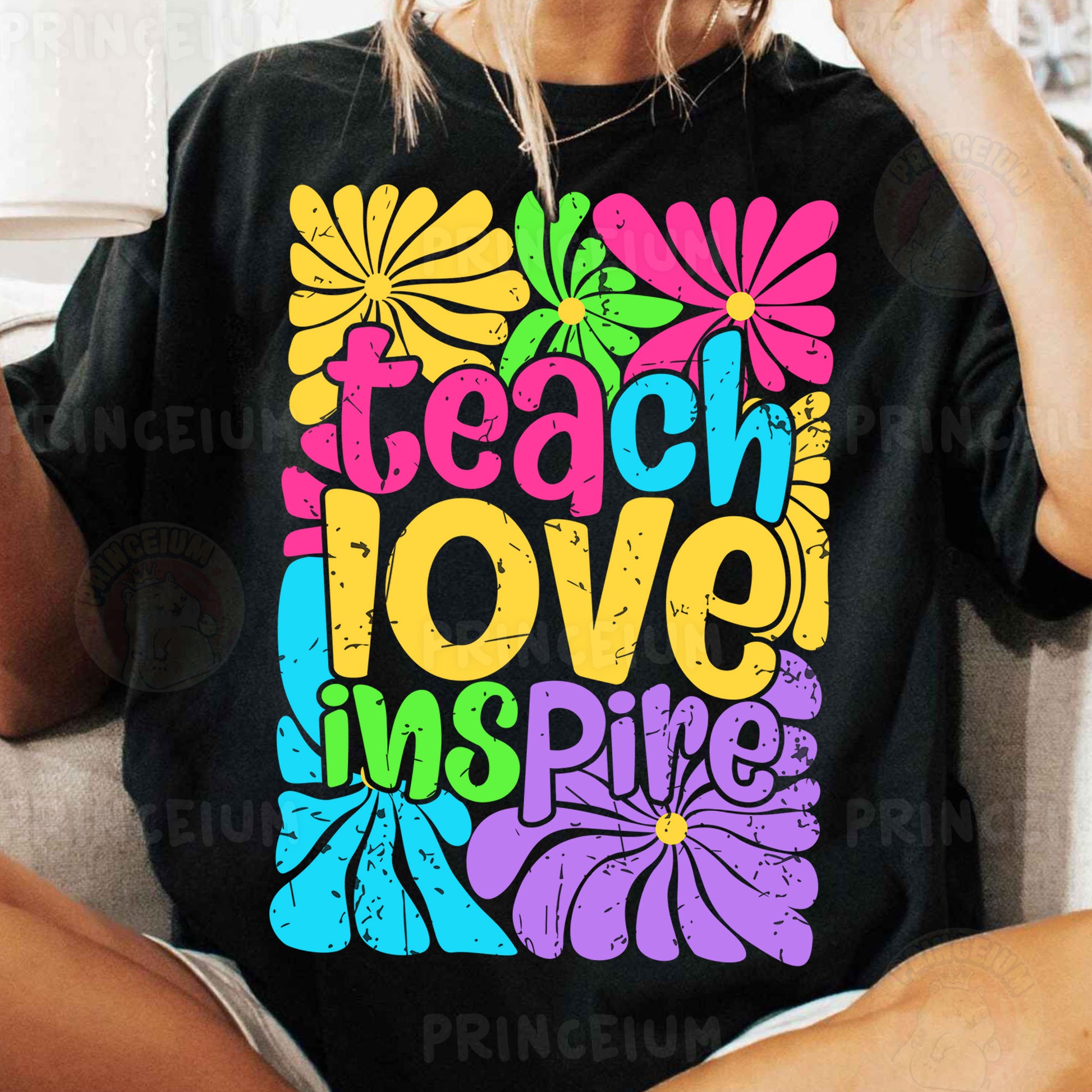 a woman sitting on a couch wearing a t - shirt that says teach love inspire