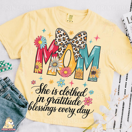 a shirt that says mom she is clothed in gratie and blessing every day