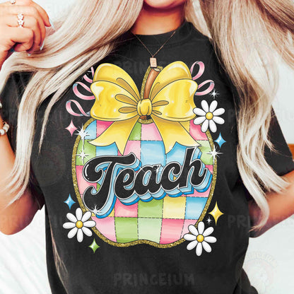a woman wearing a teacher shirt with a bow