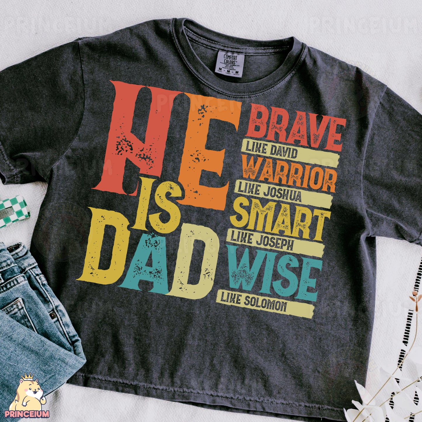 a t - shirt that says he is a dad and a pair of jeans
