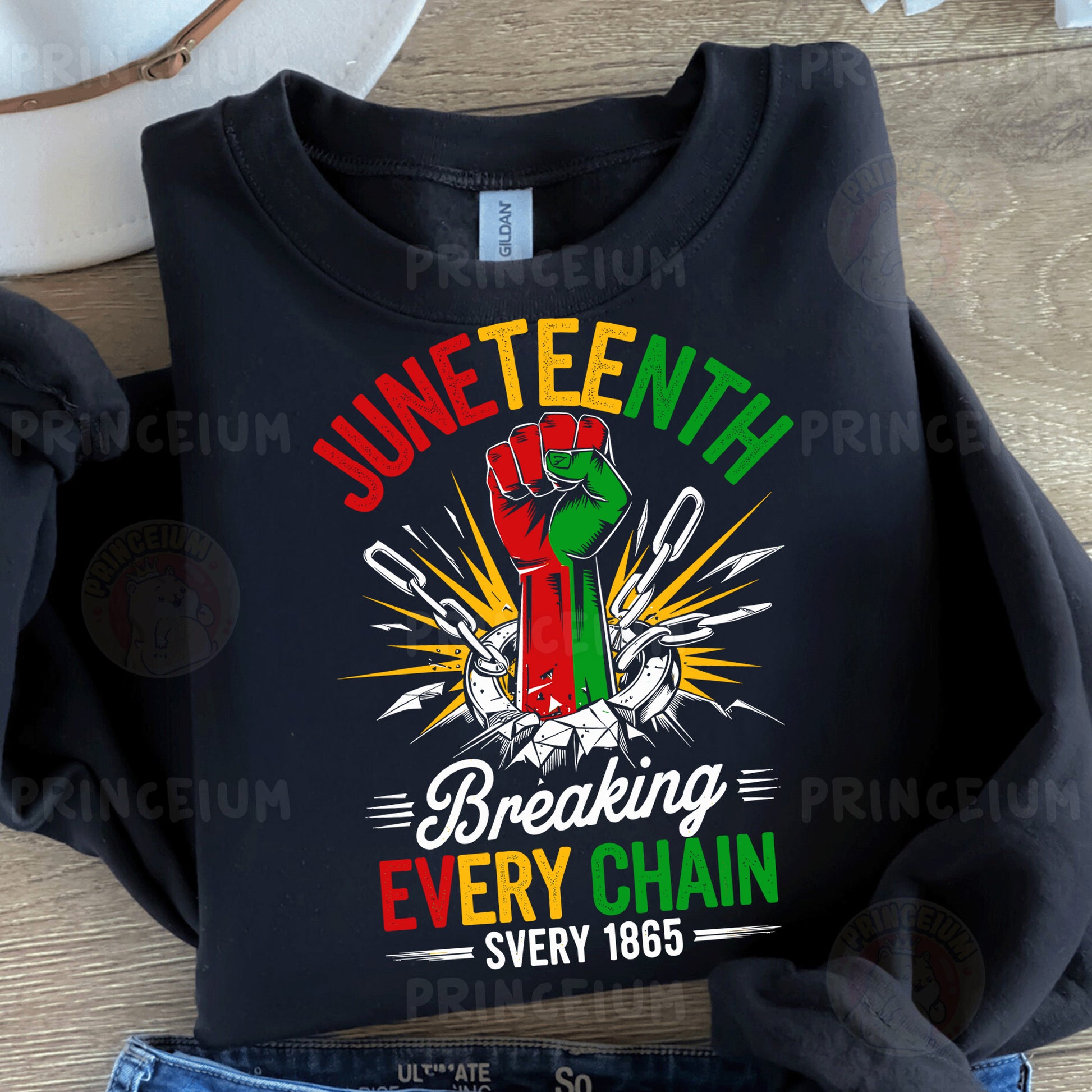a black t - shirt with the words juneteeth breaking every chain on it