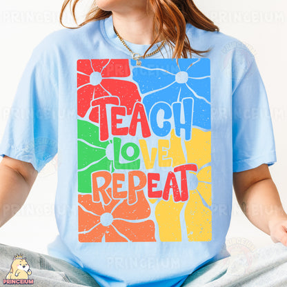 a woman sitting on the ground wearing a t - shirt with the words teach love
