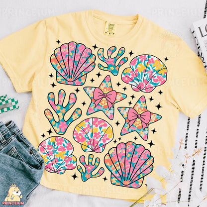 a t - shirt that has a bunch of seashells on it