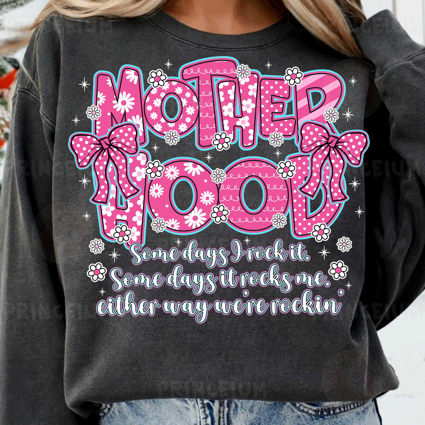 a woman wearing a sweatshirt that says motherhood