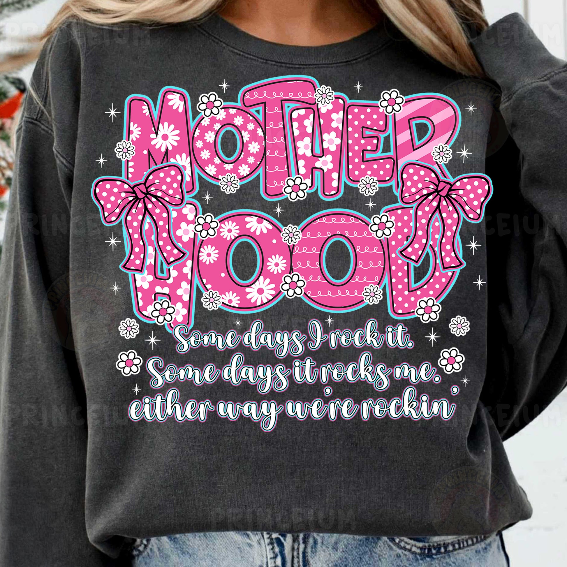 a woman wearing a sweatshirt that says motherhood