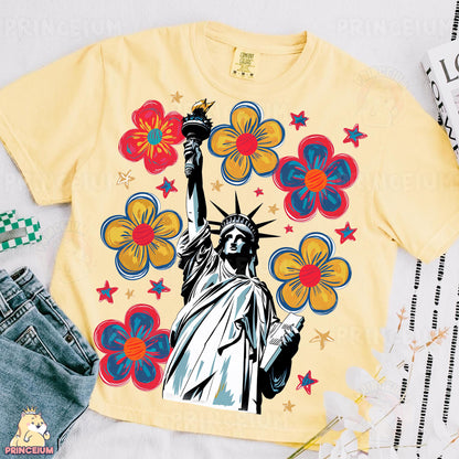 a t - shirt with the statue of liberty surrounded by flowers