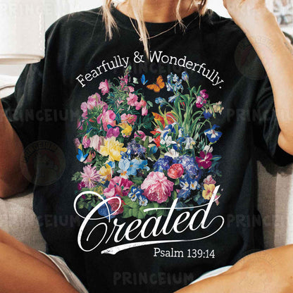 a woman sitting on a couch wearing a t - shirt with a picture of flowers