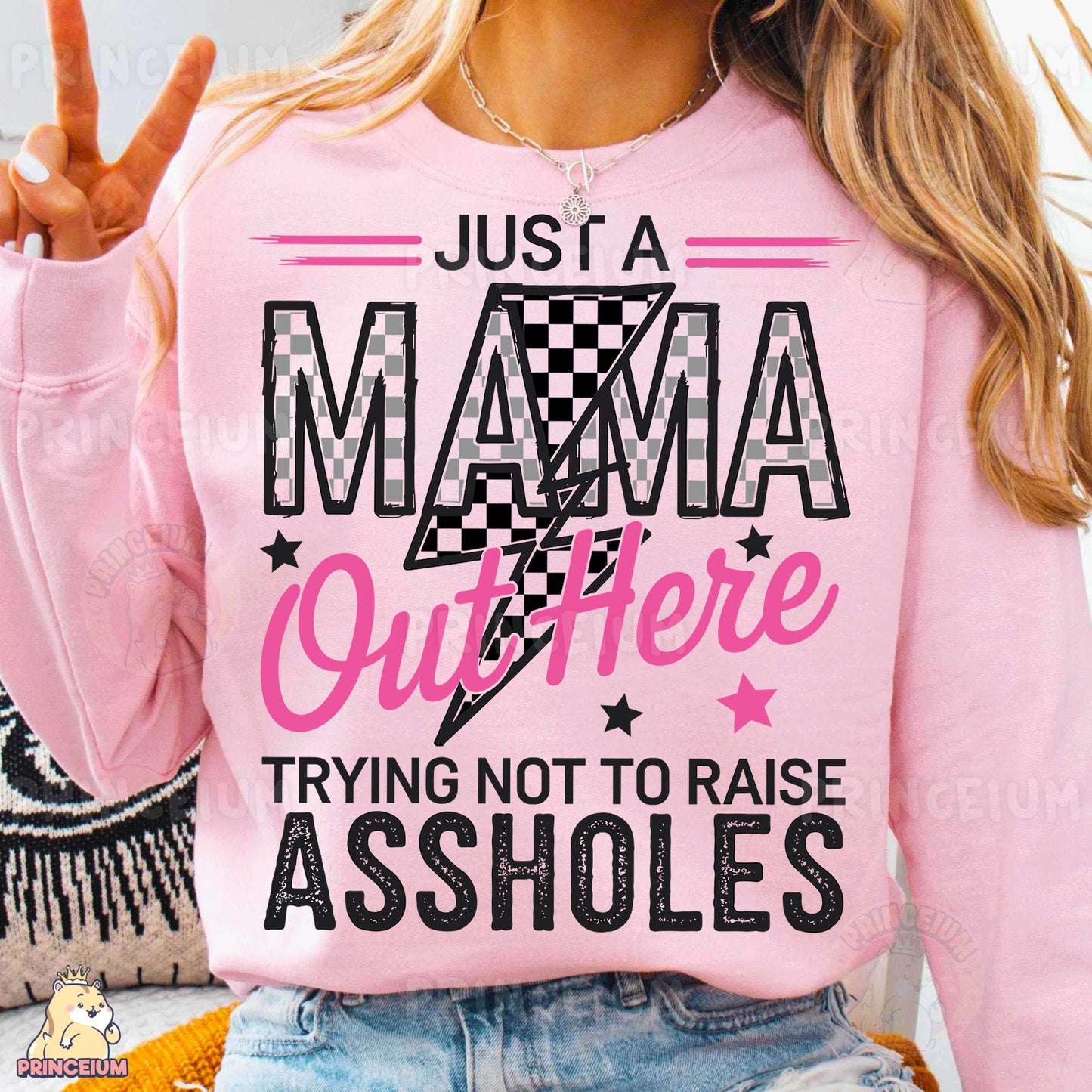 a woman wearing a pink shirt that says just a mama outside trying not to raise