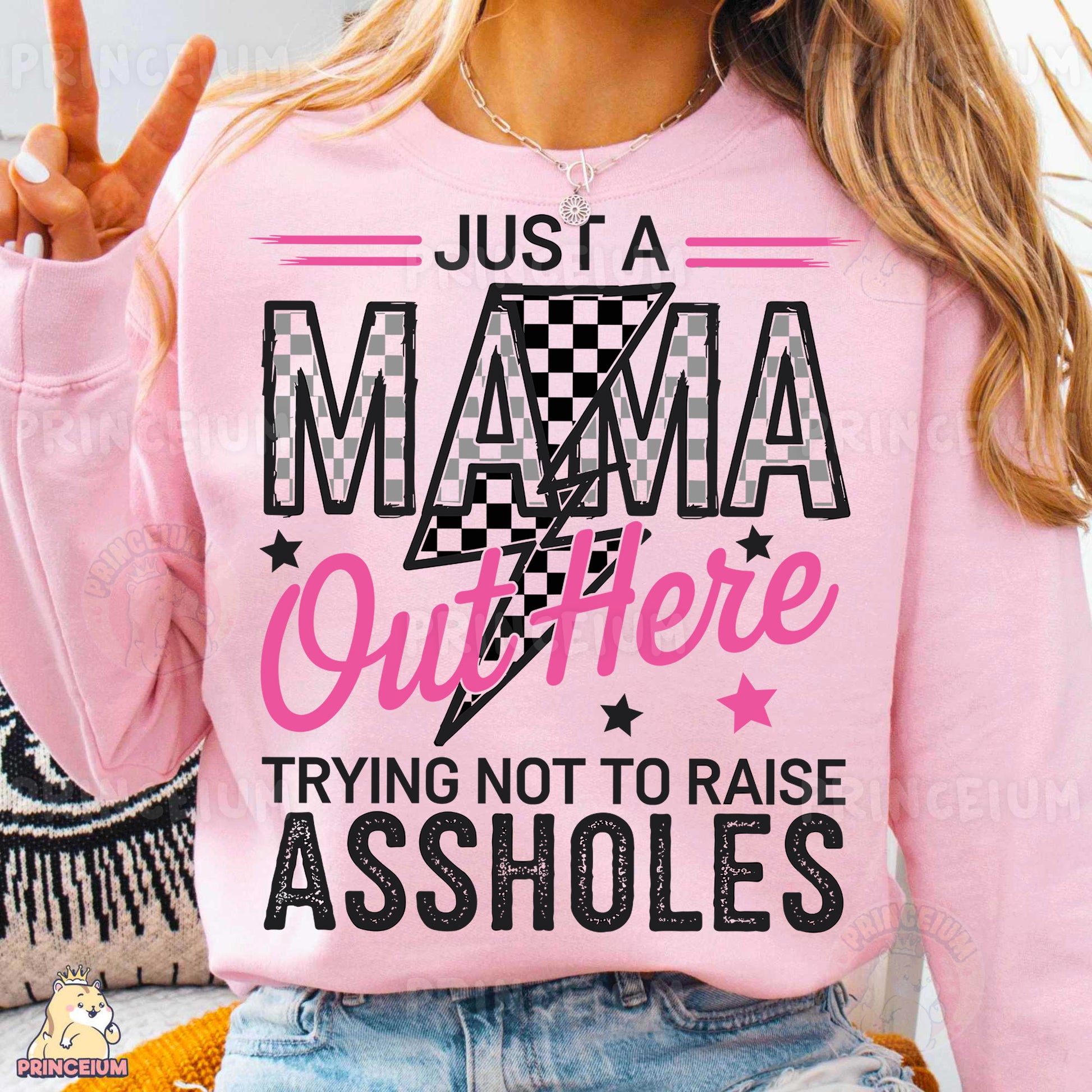 a woman wearing a pink shirt that says just a mama outside trying not to raise