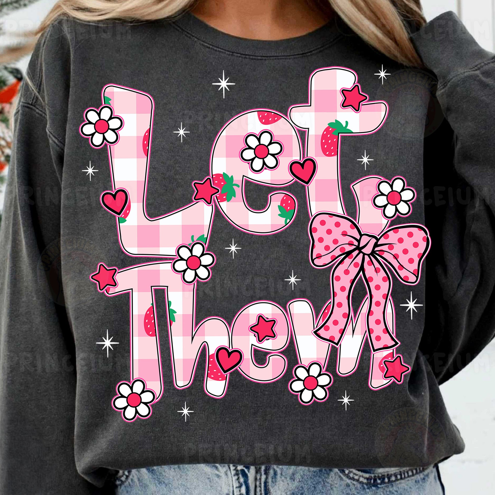 a woman wearing a black sweatshirt with a pink bow