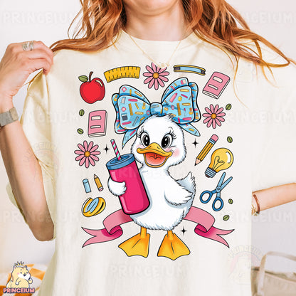 a woman wearing a t - shirt with a picture of a duck holding a drink