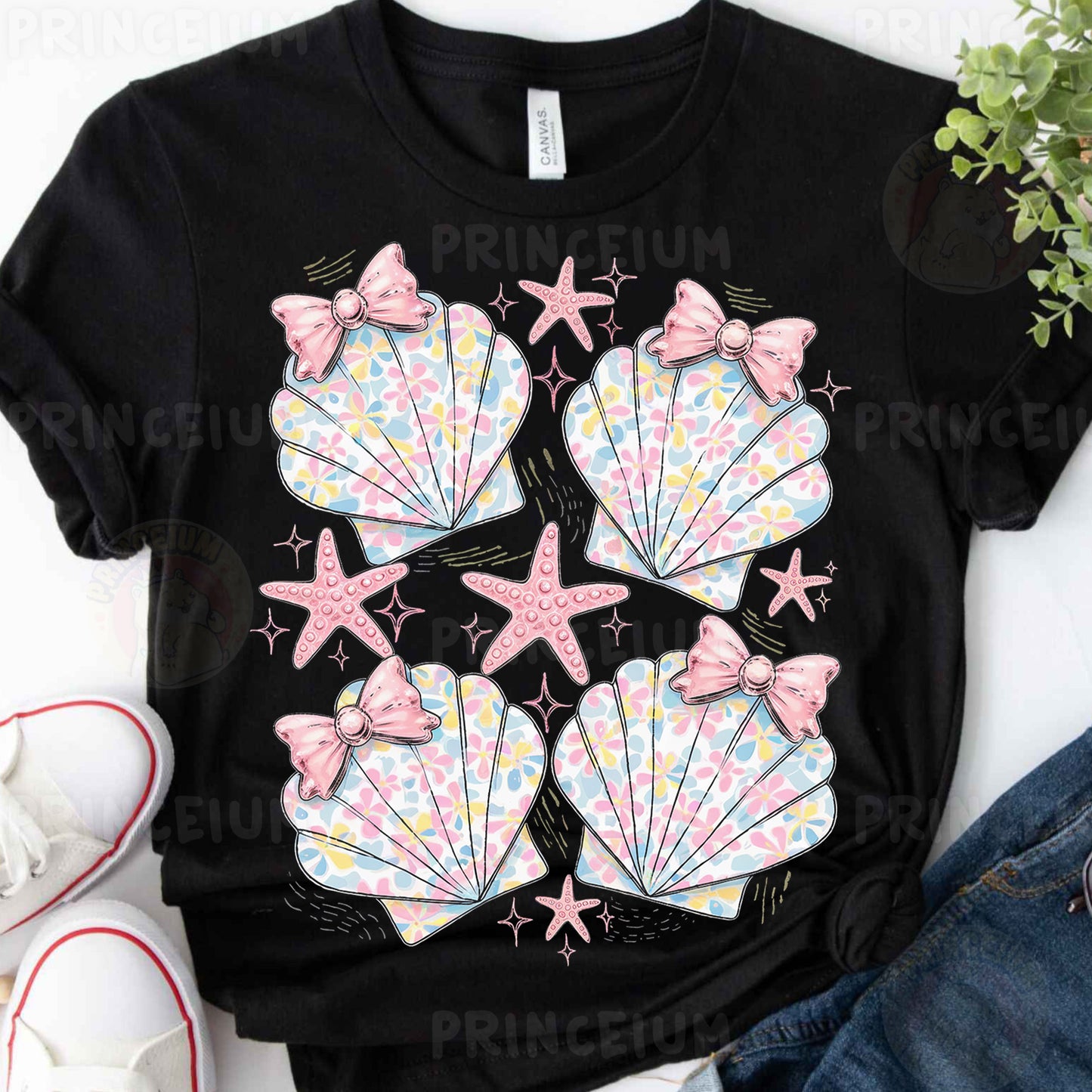 a black shirt with pink bows and seashells on it