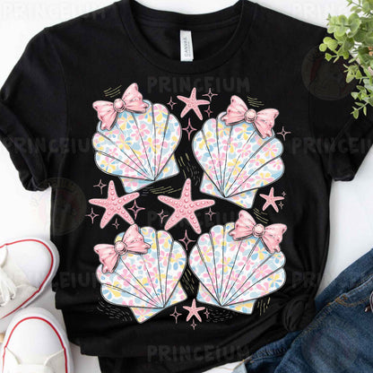 a black shirt with pink bows and seashells on it
