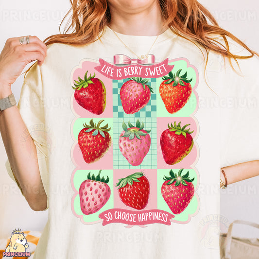 a woman wearing a t - shirt with strawberries on it
