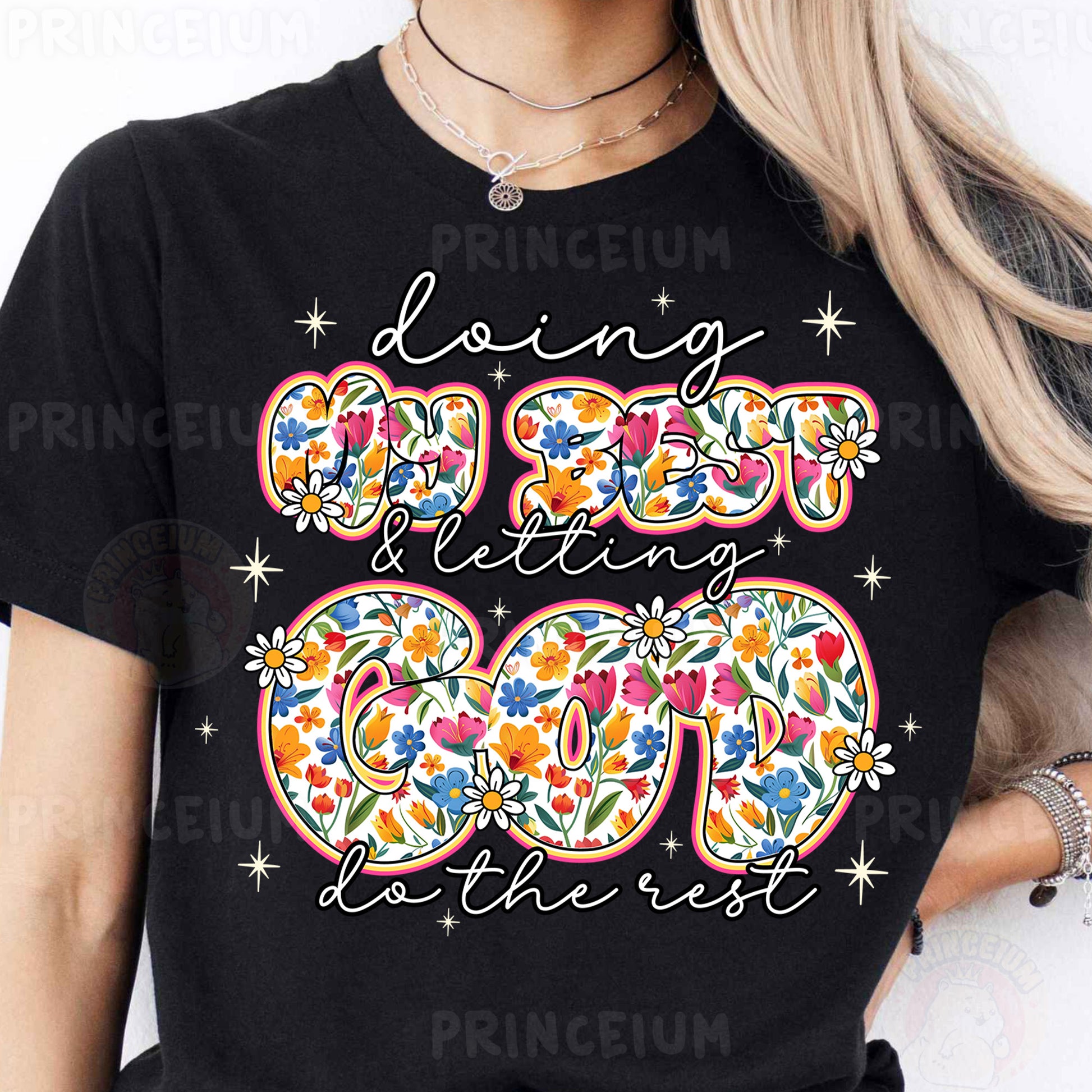 a woman wearing a black t - shirt with a floral design