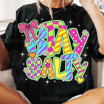 a woman sitting on a couch wearing a t - shirt that says stay salty
