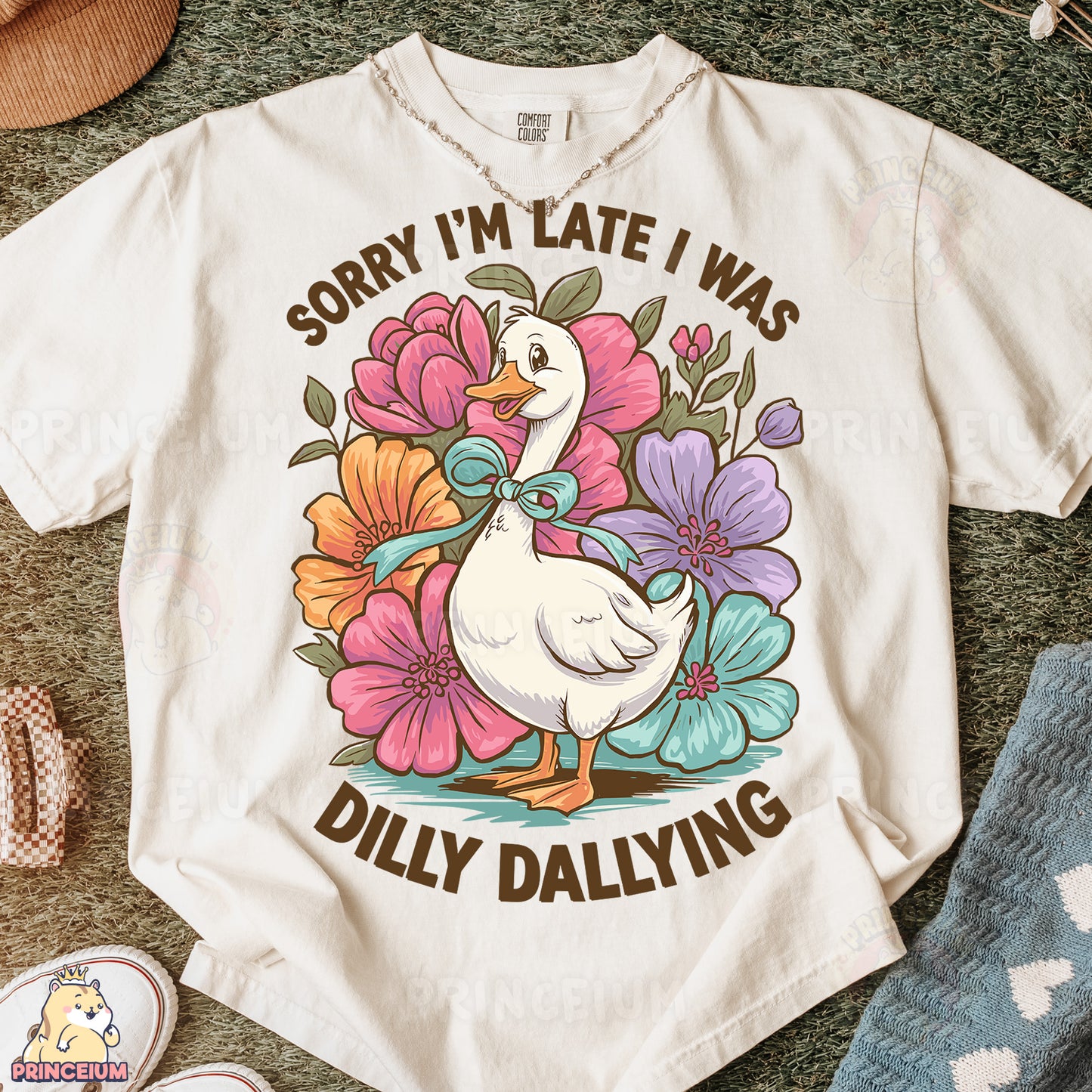 a white t - shirt with a duck and flowers on it