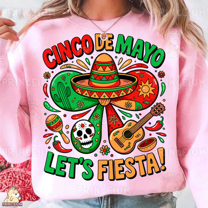 a woman wearing a pink cinco de mayo let's fiesta sweatshirt