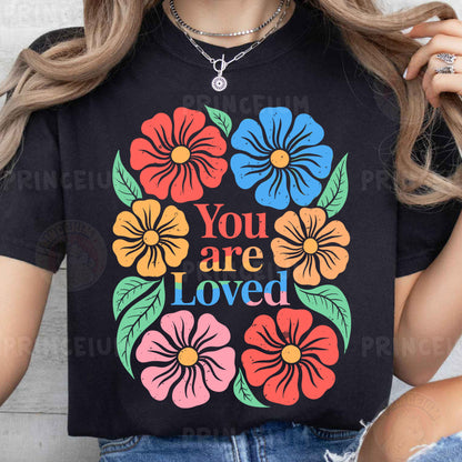 a woman wearing a t - shirt that says you are loved
