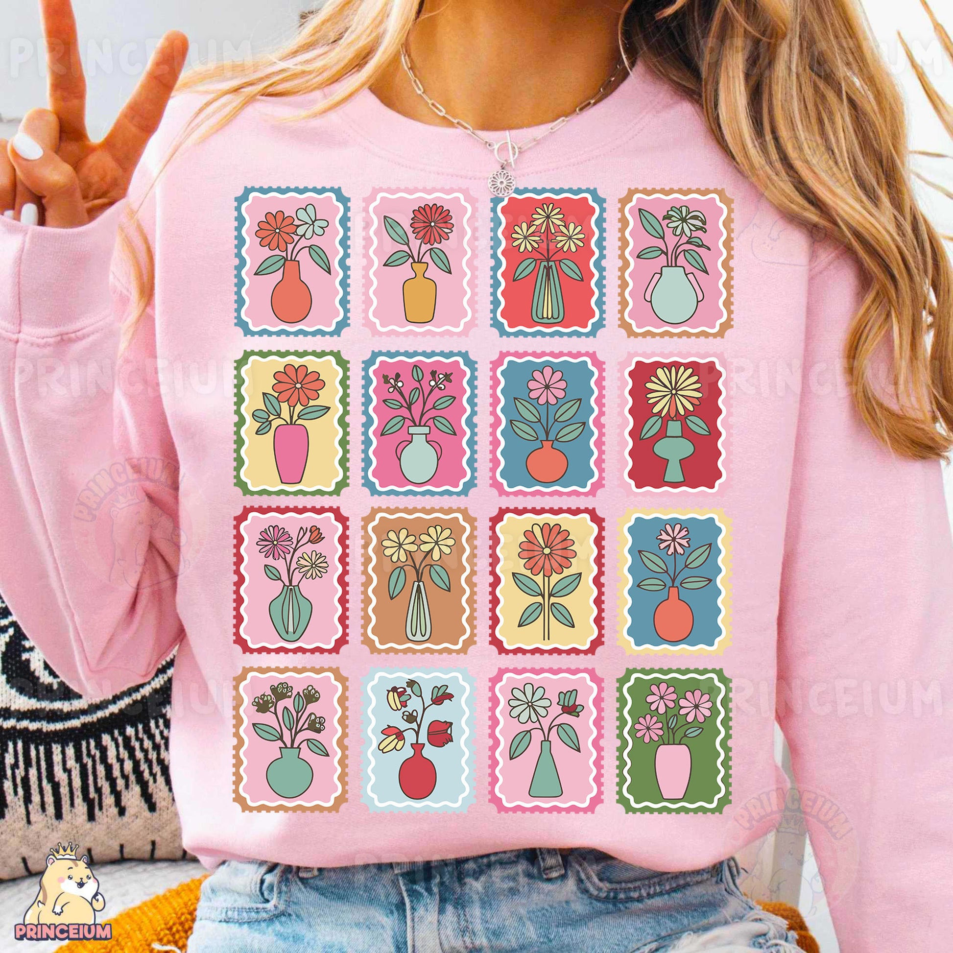 a woman wearing a pink sweater with flowers on it
