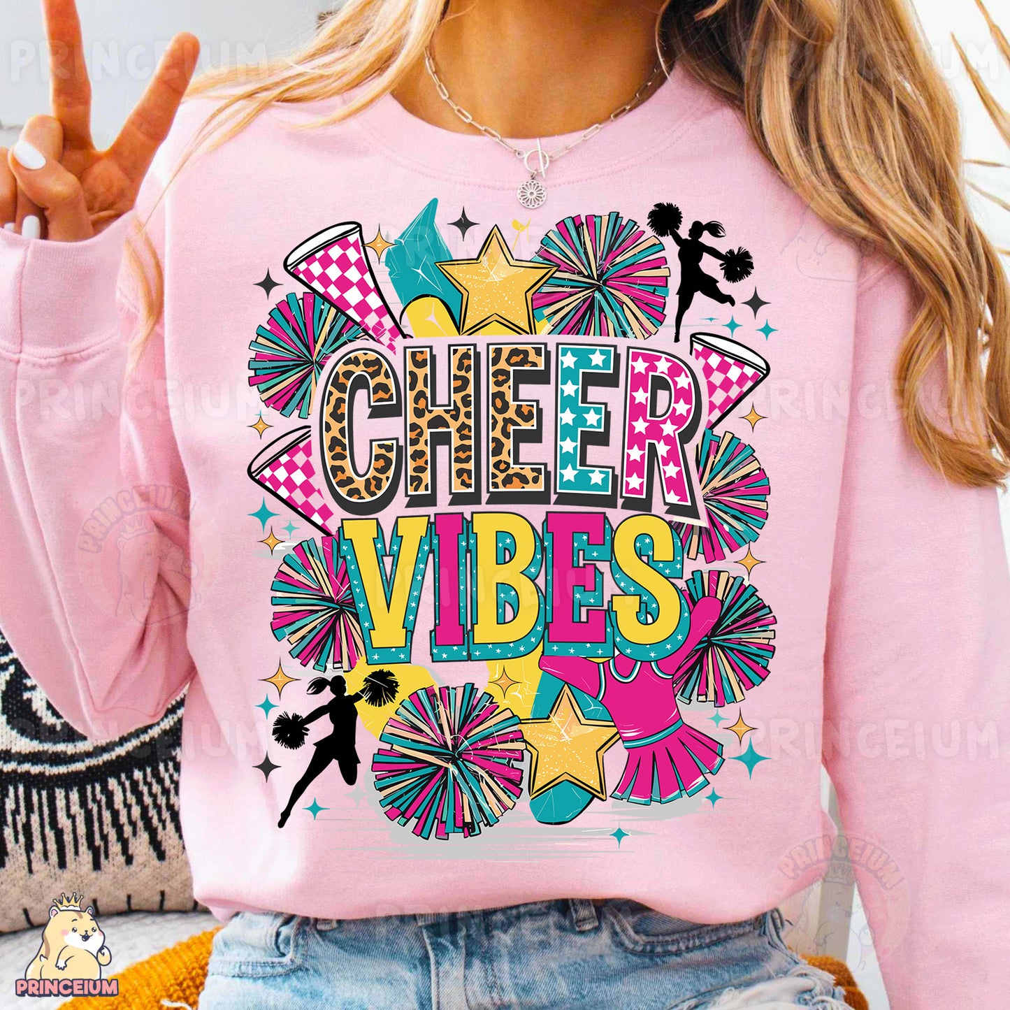 a woman wearing a pink shirt that says cheer vibes