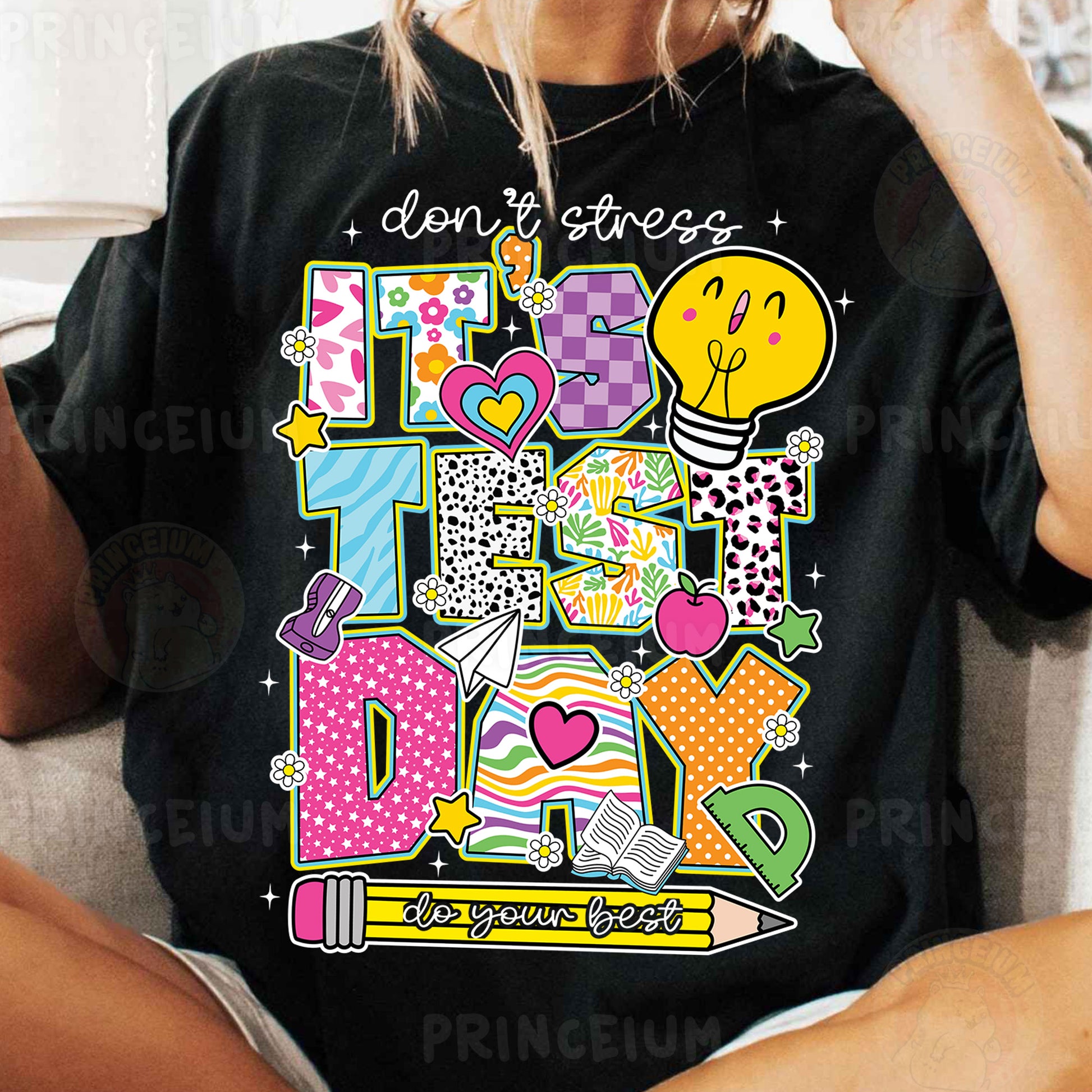 a woman sitting on a couch wearing a black t - shirt