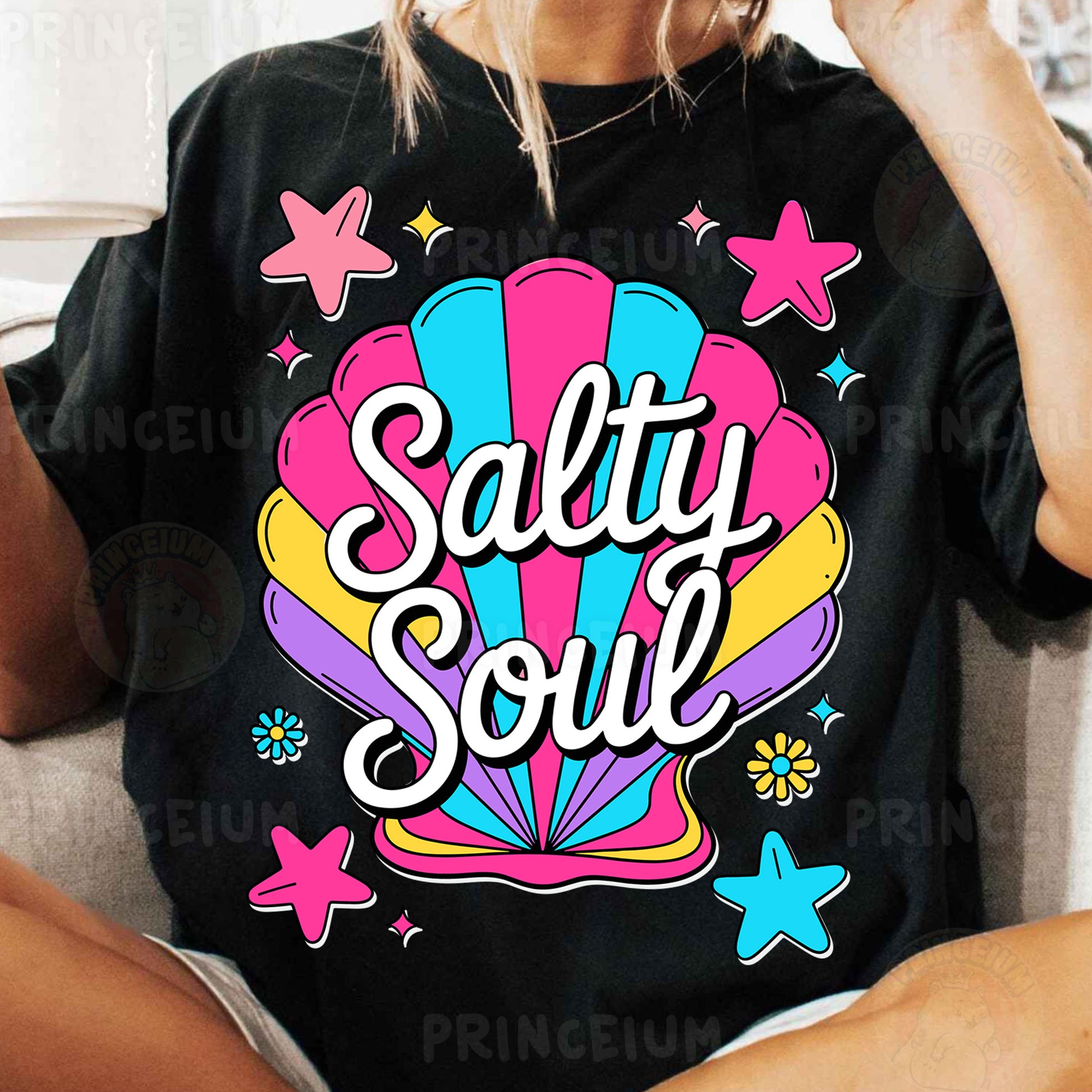 a woman sitting on a couch wearing a t - shirt that says salty soul