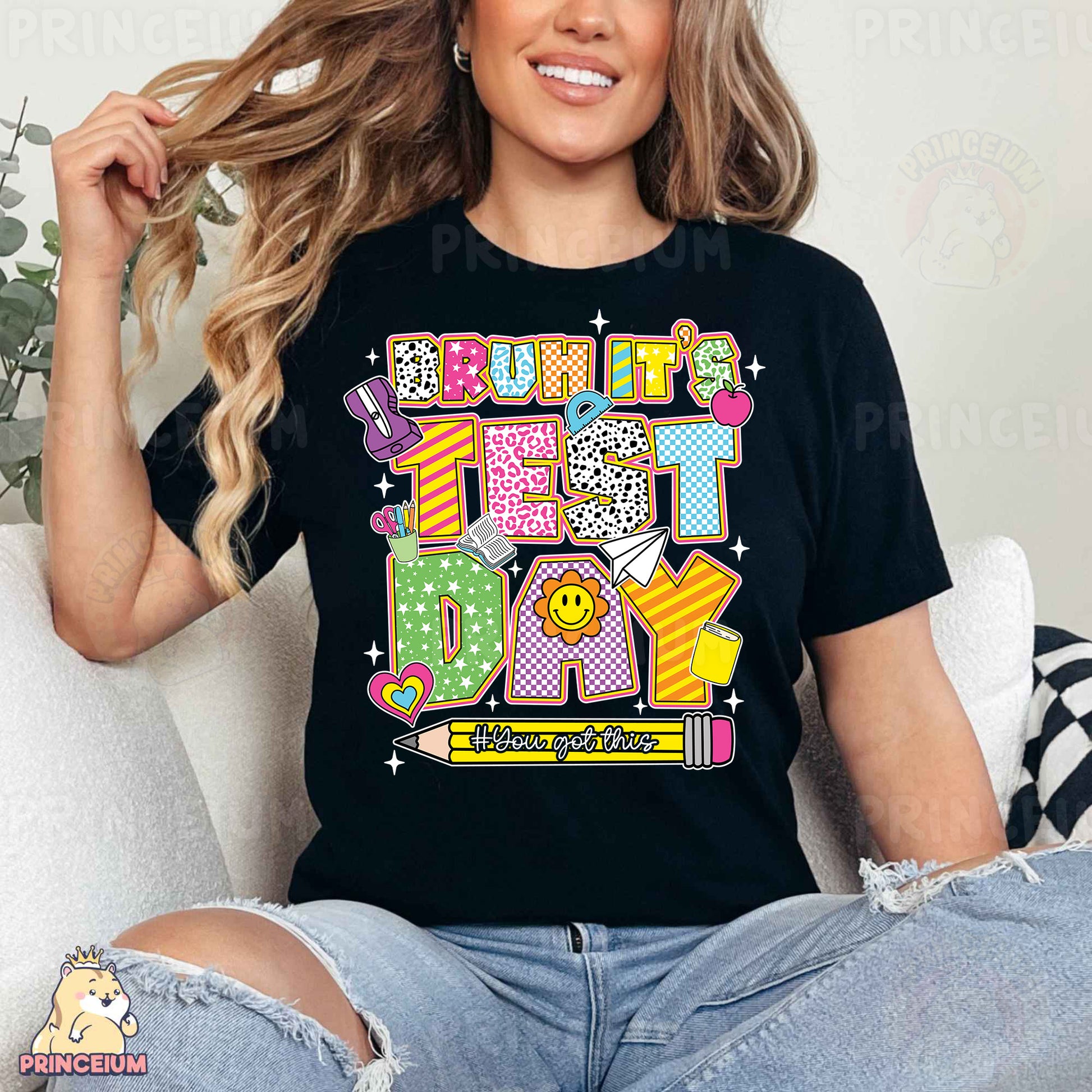 a woman sitting on a couch wearing a black shirt