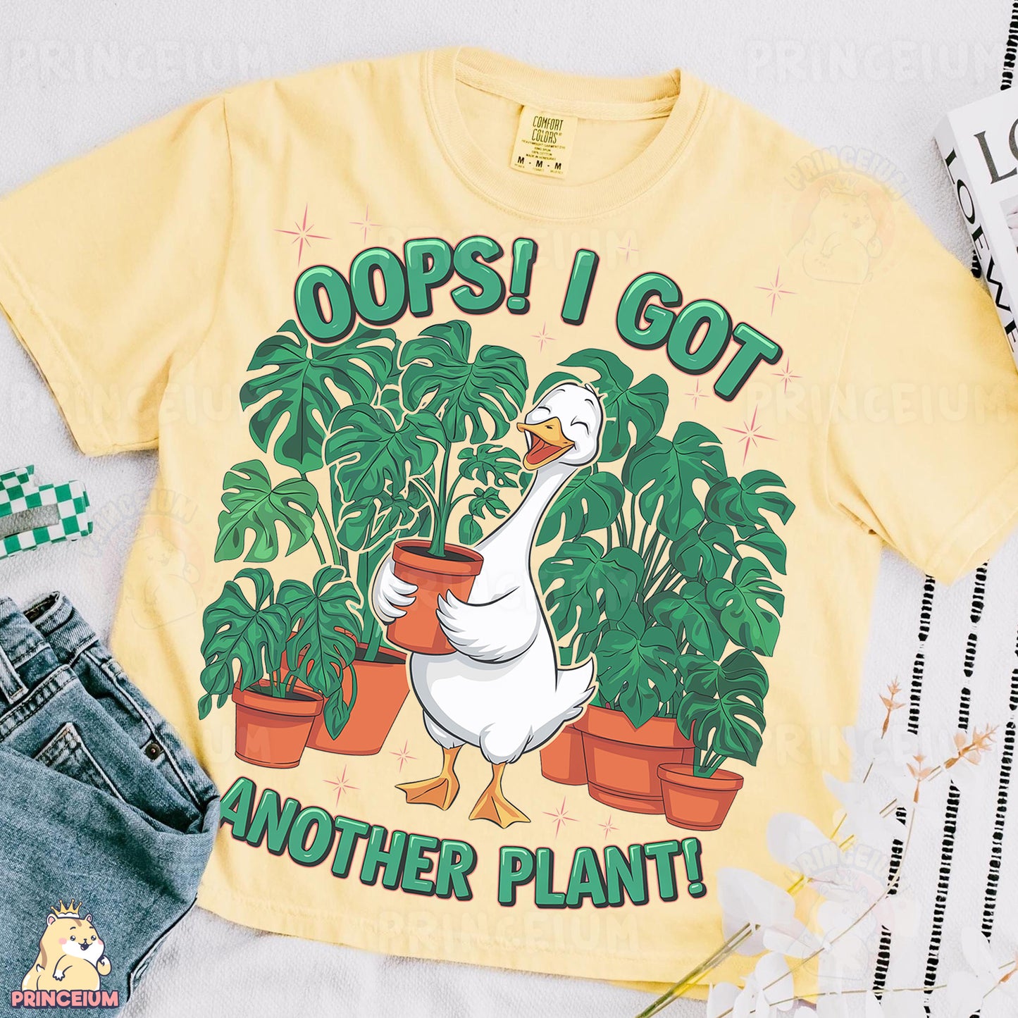 a yellow shirt with a goose and potted plants on it