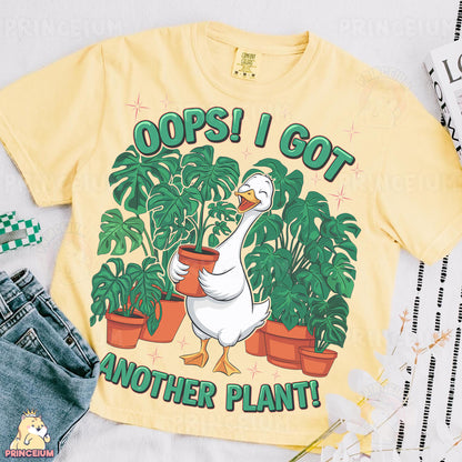 a yellow shirt with a goose and potted plants on it