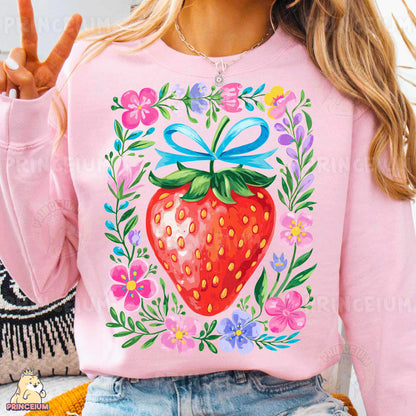 a woman wearing a pink shirt with a strawberry on it