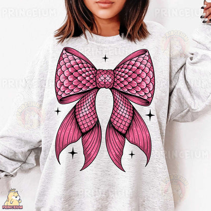 a woman wearing a sweatshirt with a pink bow on it