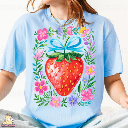 a woman wearing a blue shirt with a strawberry on it