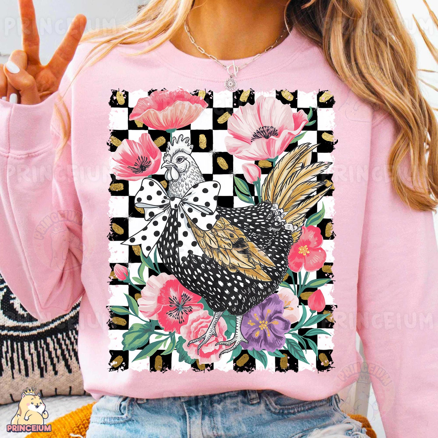 a woman wearing a pink sweater with a chicken on it