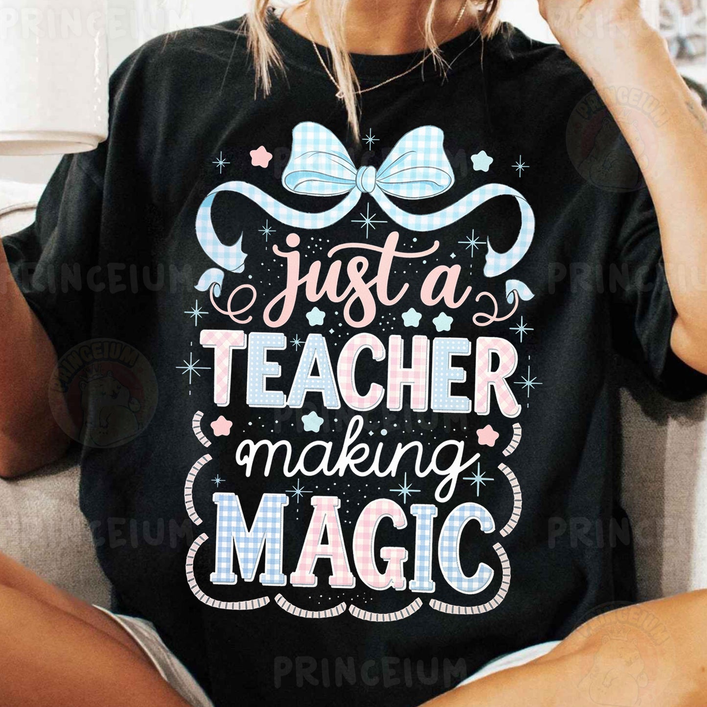 a woman sitting on a couch wearing a t - shirt that says just a teacher