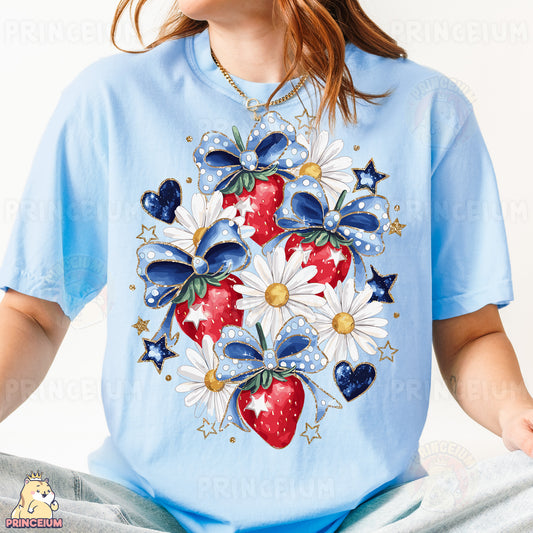a woman wearing a blue t - shirt with a strawberry and daisies on it