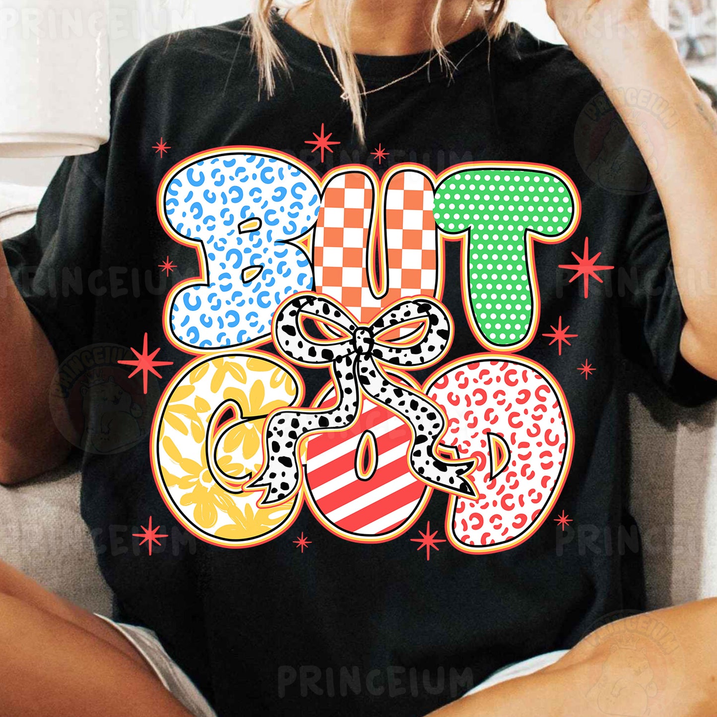 a woman sitting on a couch wearing a t shirt