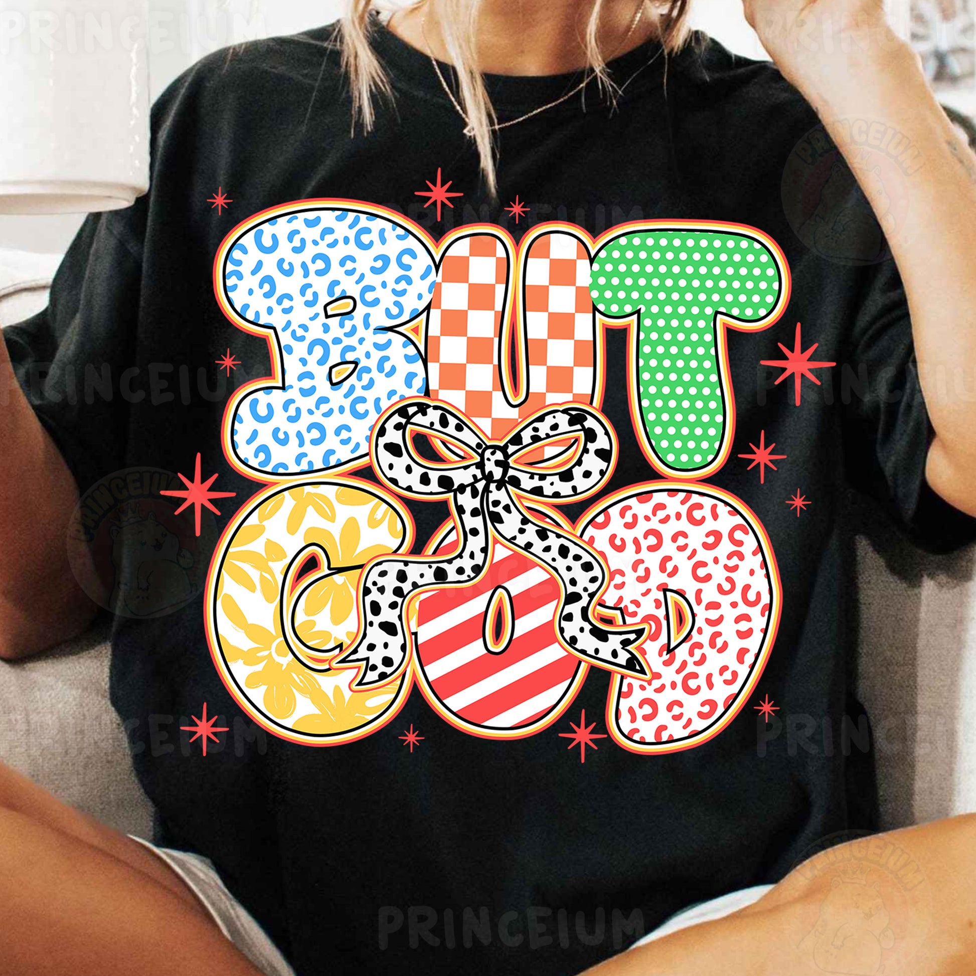 a woman sitting on a couch wearing a t shirt