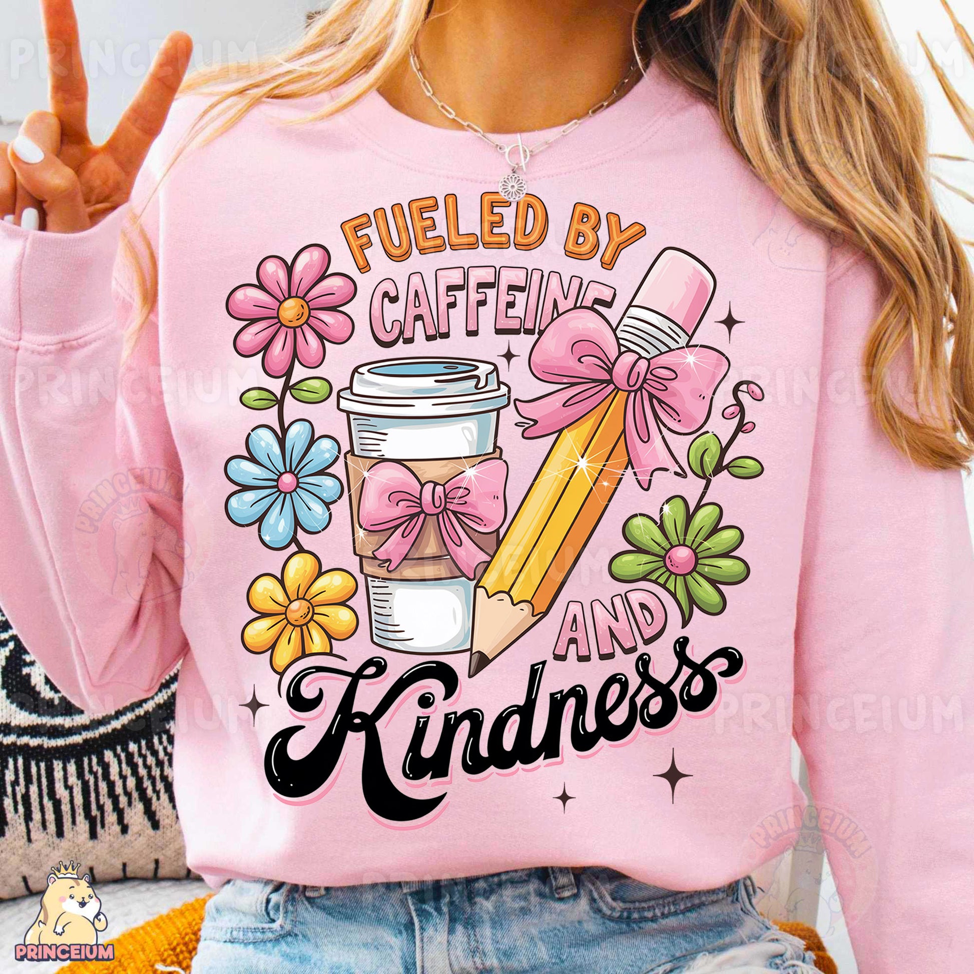 a woman wearing a pink sweatshirt that says fueled by caffeine and kindness