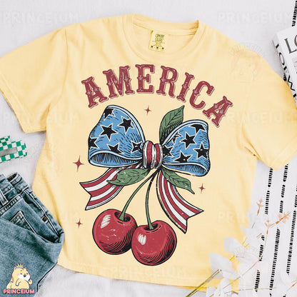 a yellow shirt with an american flag bow and cherries